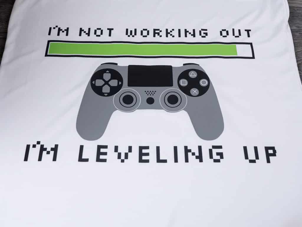 A shirt that reads "I'm not working out I'm leveling up" with a controller in Black, Apple Green, and Storm Grey ThermoFlex Plus