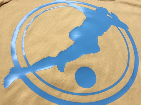 A shirt with a man playing soccer made with Baby Blue ThermoFlex Light
