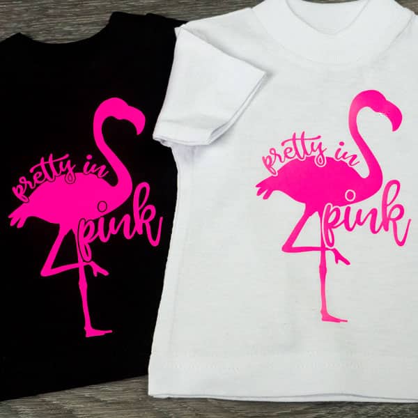 Two flamingos, one on a black shirt and one on a white, in Pink ThermoFlex Plus Neon HTV