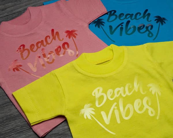 The words "Beach Vibes" made with Brilliant Clear DecoFilm that had been sublimated to give it a gradient.
