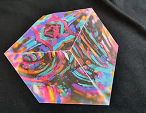 A colorful cube printed and pressed onto CL Dark Premium