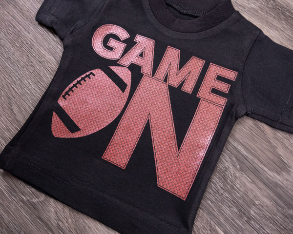 A shirt that reads "Game On" with a football in Carbonium Red FashionFlex