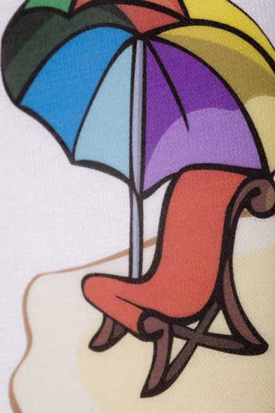 A close up of an image printed and pressed using ColorJet 3 Light- it shows a beach and a chair with a colorful umbrella