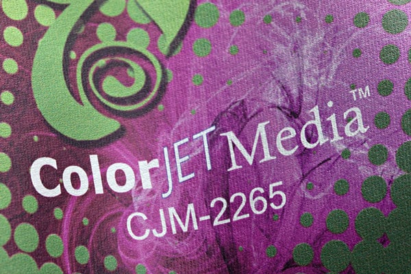 A close up of an image reading "ColorJet Media CJM-2265" with decorative elements in the background printed on ColorJet Media Solvent Printable