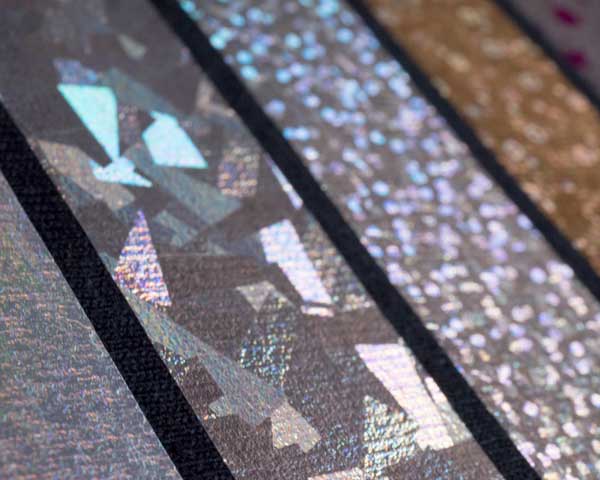 A close up of various pressed swatches of DecoFIlm Soft Metallics