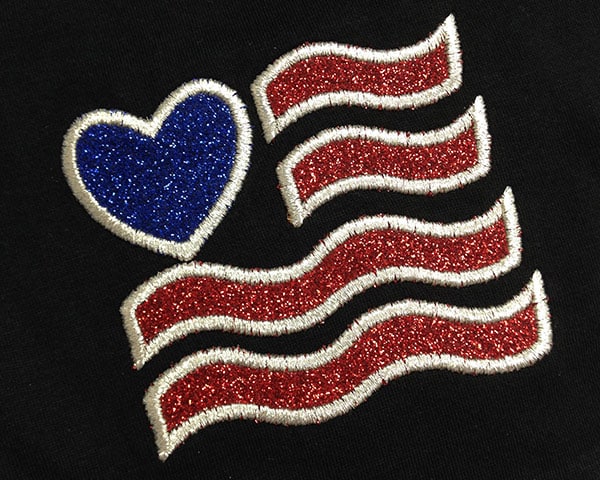 An embroidered flag made using Embroidery Glitter