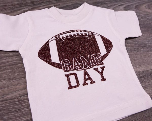 A shirt reading "Game Day" over a football made with Brown GlitterFlex Ultra