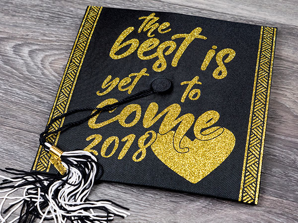 A graduation cap with the words "The best is yet to come 2018" made in Gold GlitterFlex Ultra