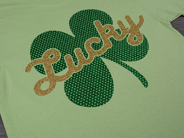 A shirt with a four leaf clover and the word "Lucky" made with GlitterFlex Ultra Perf and GlitterFlex Ultra