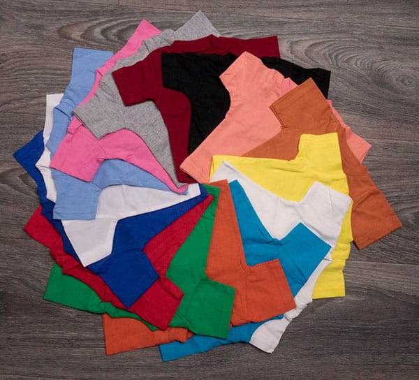 The variety of colors of mini-tees arranged in a pinwheel