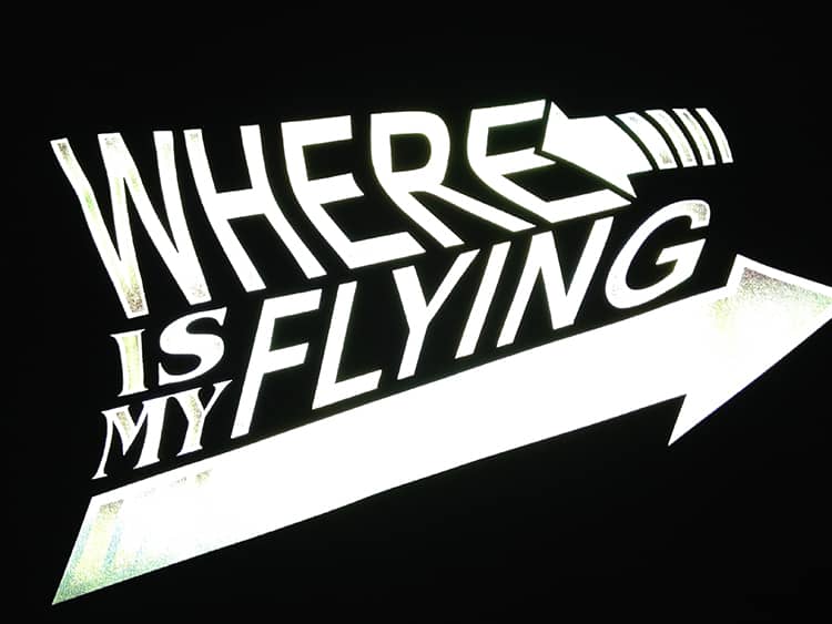 A design reading "Where is My Flying Skateboard" printed in Silver ReflectivePrintable with light being shined on it to show how reflective it is