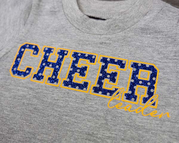The words "Cheerleader" made with Royal Blue GlitterFlex Ultra Perf and Athletic Gold ThermoFlex Plus