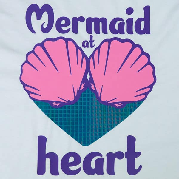 A shirt that reads "Mermaid at heart" with a heart and seashells made with Rainbow Square DesignFilm and ThermoFlex Plus
