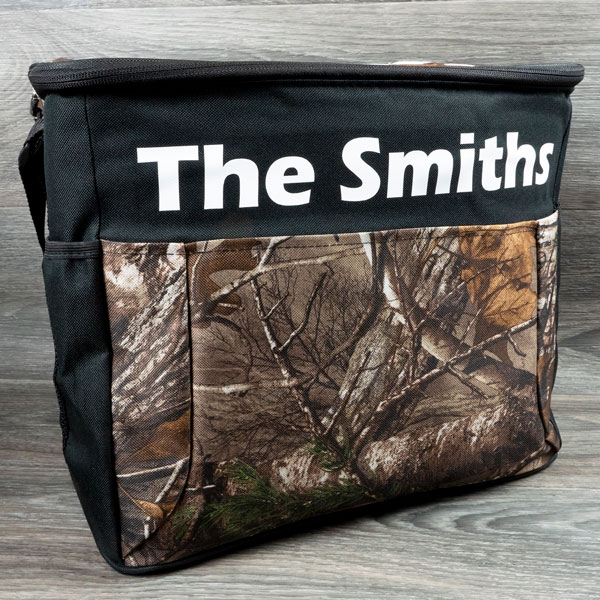 A cloth cooler with a camo material- it has "The Smiths" pressed in White ThermoFlex Turbo