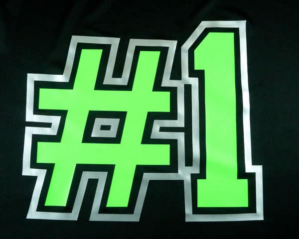 A shirt that reads "#1" made with Antique Silver and Neon Green Subliblock Turbo