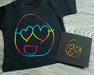 A smiley face image that was traced and turned into a cut file and pressed onto a shirt with Rainbow Multi DecoFilm Soft Metallics