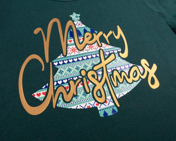 A design with a Christmas tree that says "Merry Christmas" made using ThermoFlex Turbo Brights and Christmas Sweater ThermoFlex Fashion Patterns