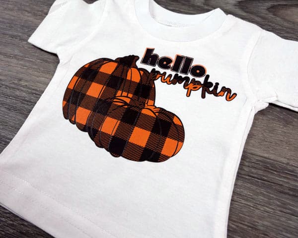 A shirt with pumpkins reading "Hello pumpkin" made with ThermoFlex Plus and Buffalo Plaid Orange ThermoFlex Fashion Patterns