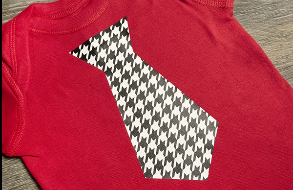A tie on a baby onesie made with Houndstooth ThermoFlex Fashion Patterns
