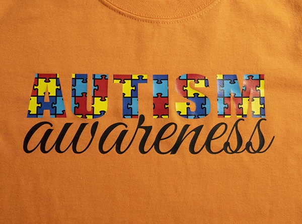 A shirt that says "Autism Awareness" made with Jigsaw Autism ThermoFlex Fashion Patterns and ThermoFlex Plus