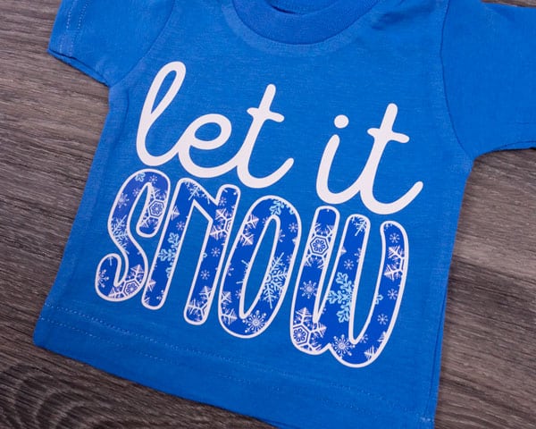 A shirt that says "Let it snow" created with ThermoFlex Plus and Snowflake ThermoFlex Fashion Patterns Festive
