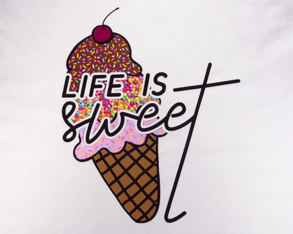 An ice cream cone with the words "Life is sweet" made using with Sprinkles Chocolate, Hundreds & Thousands, and Sprinkles Pink ThermoFlex® Fashion Patterns and Black ThermoFlex® Plus.