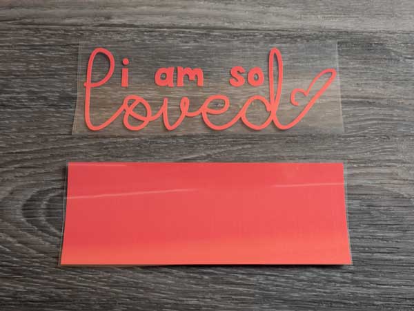 The ThermoFlex Plus before weeding and after- the design reads "I am so loved"