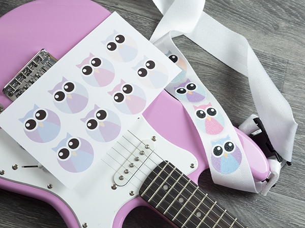 A guitar strap pressed with GlitterFlex Ultra that has been sublimated with a cute owl image