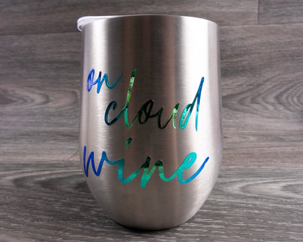 A metal wine glass with the words "On cloud wine" in Blue Chameleon