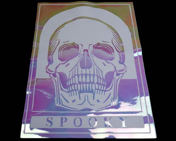 A skull with the words "Spooky" made with Neon Rainbow White DecoFilm® Brilliant Chameleon and a base layer of White ThermoFlex® Plus