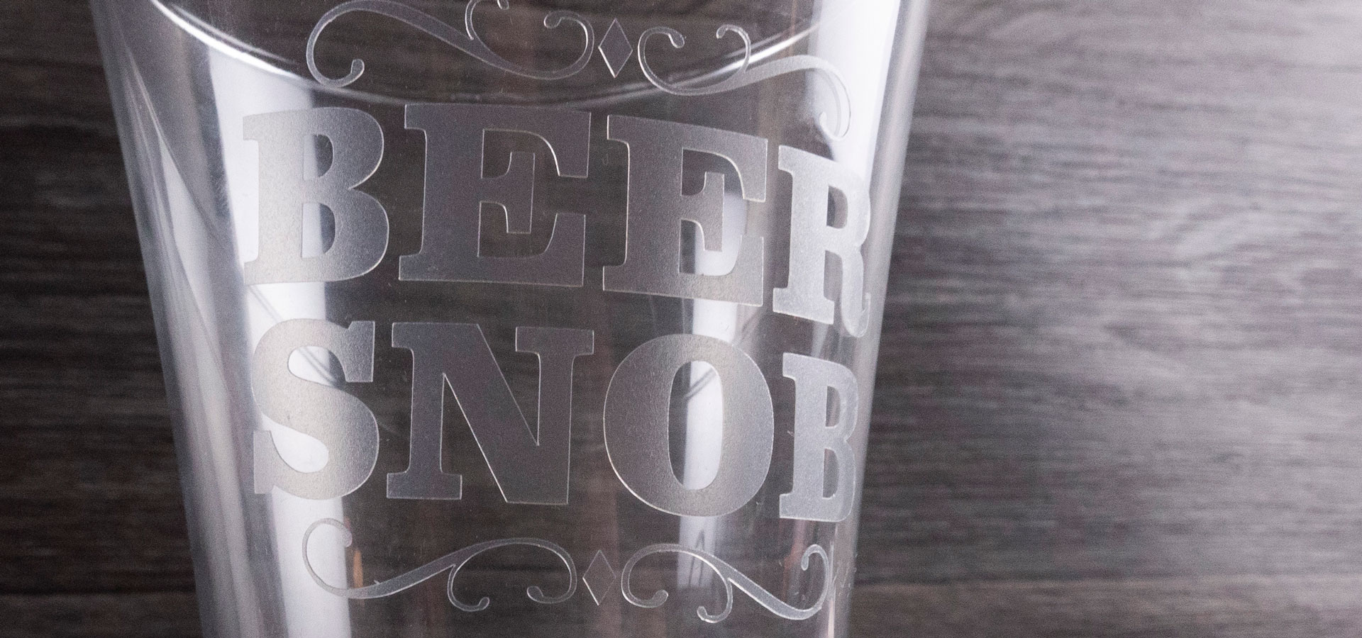 A beer glass reading "Beer Snob" made with White Etched