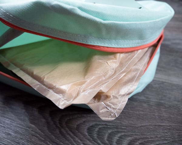 Showing the inside of a backpack after a pressing pillow has been placed inside