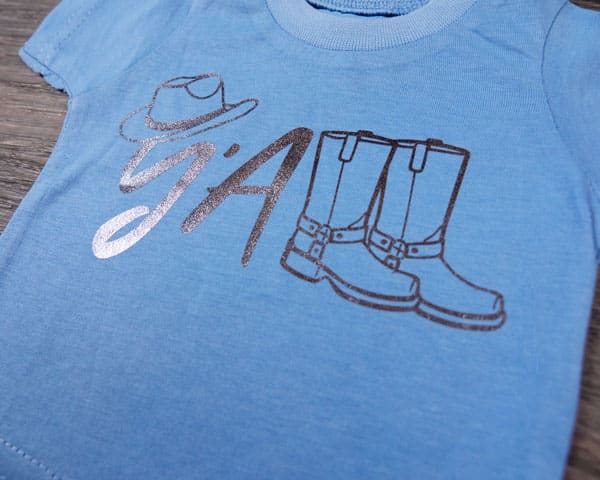 A design that says "y'all" with cowboy boots and hat in Black PearlFlex