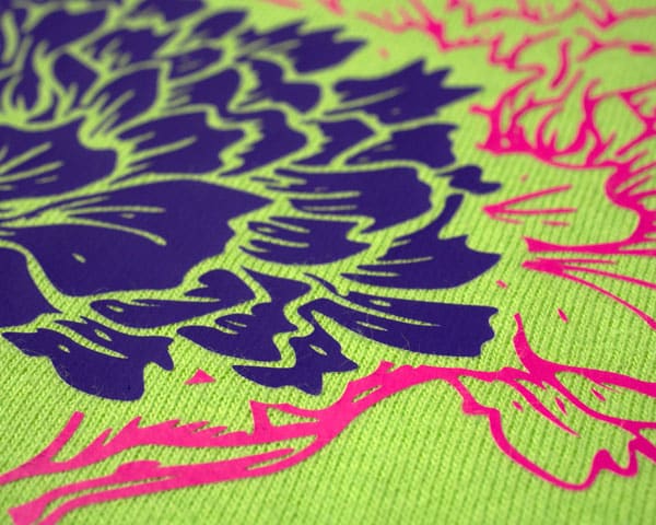 A close up picture of a flower design cut using ThermoFlex Plus. You can see how the Plus takes on the texture of the shirt.