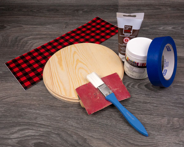 The supplies needed for this blog post- a wooden round, sand paper, brush, paint, painter's tape, and SpecialtyPSV Fashion Patterns.