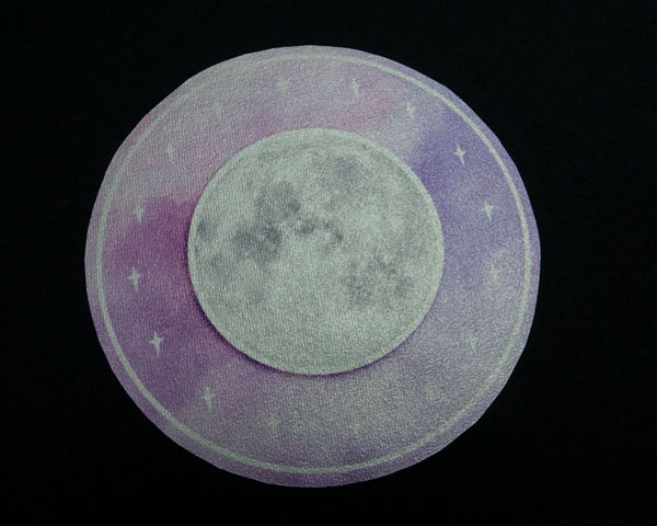 An image of a moon and a purple watercolor background that has been sublimated onto SubliFlex®