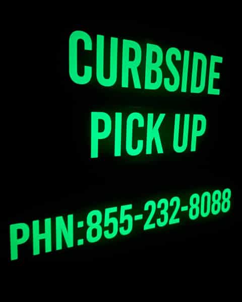 A curbside sign showing off its glow in the dark capabilities.
