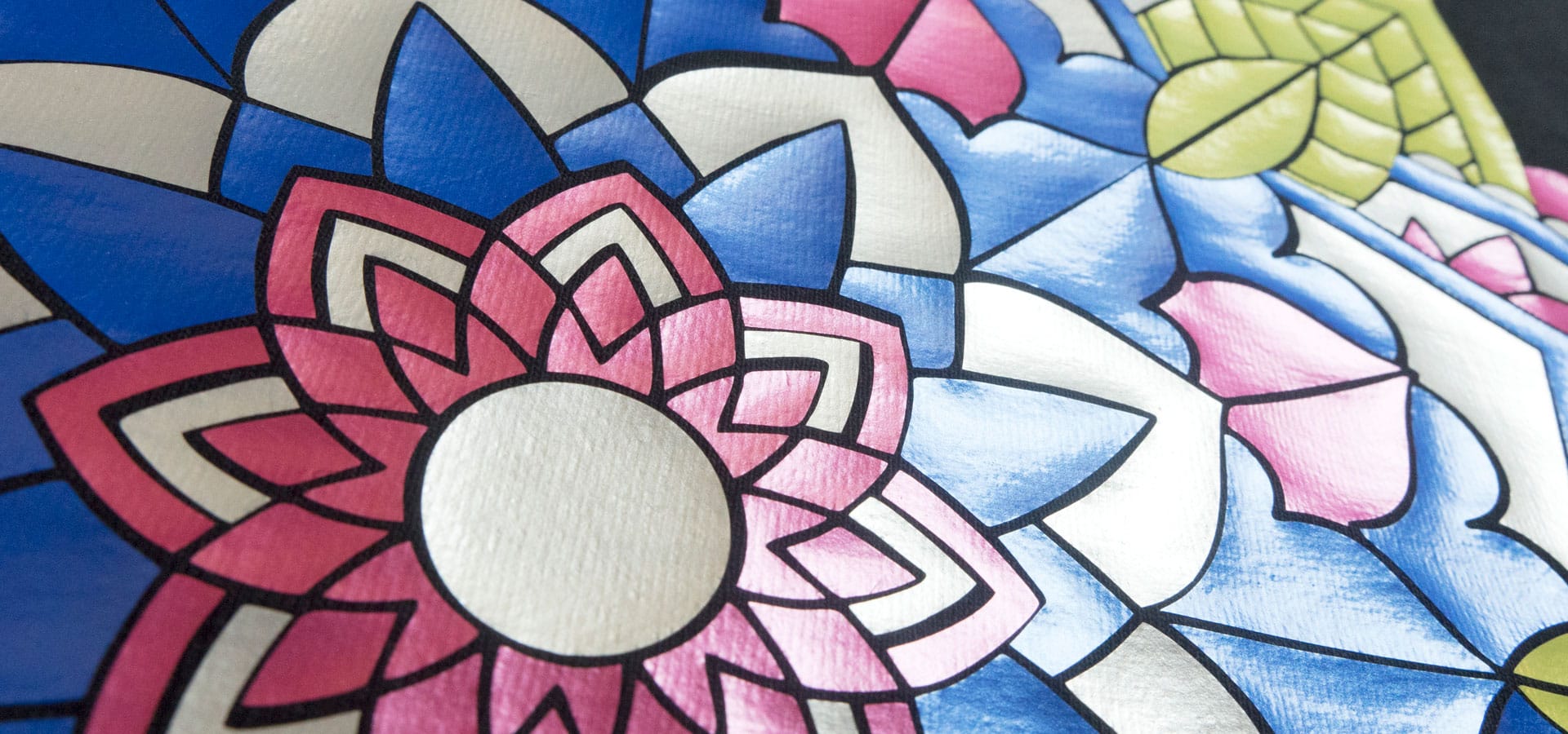 A close up of a detailed manadala design made using Cobalt Blue, Pearl White, Lime Yellow, and Watermelon DecoFilm Paint FX