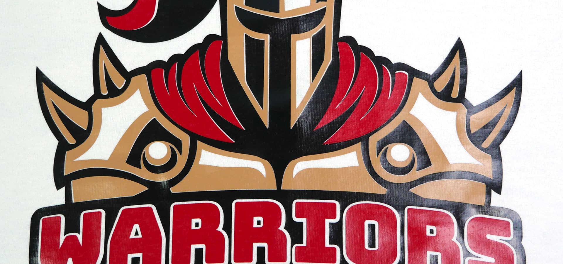 A design of a man in armor with the word "Warriors" underneath it made with Red, Camel, and Black EconomyFlex™