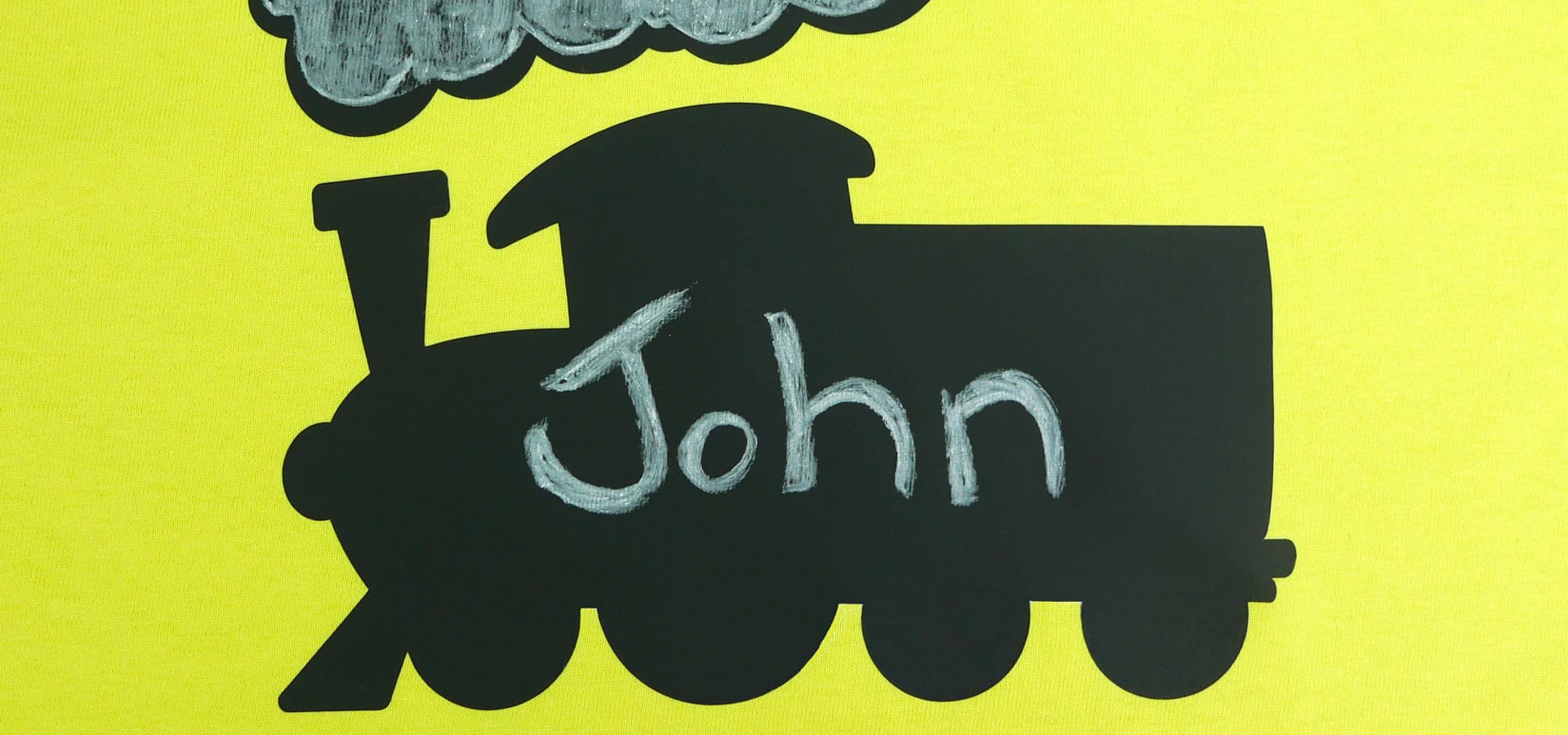 A train silhouette made with Chalkboard with the name "John" written on it in chalk.