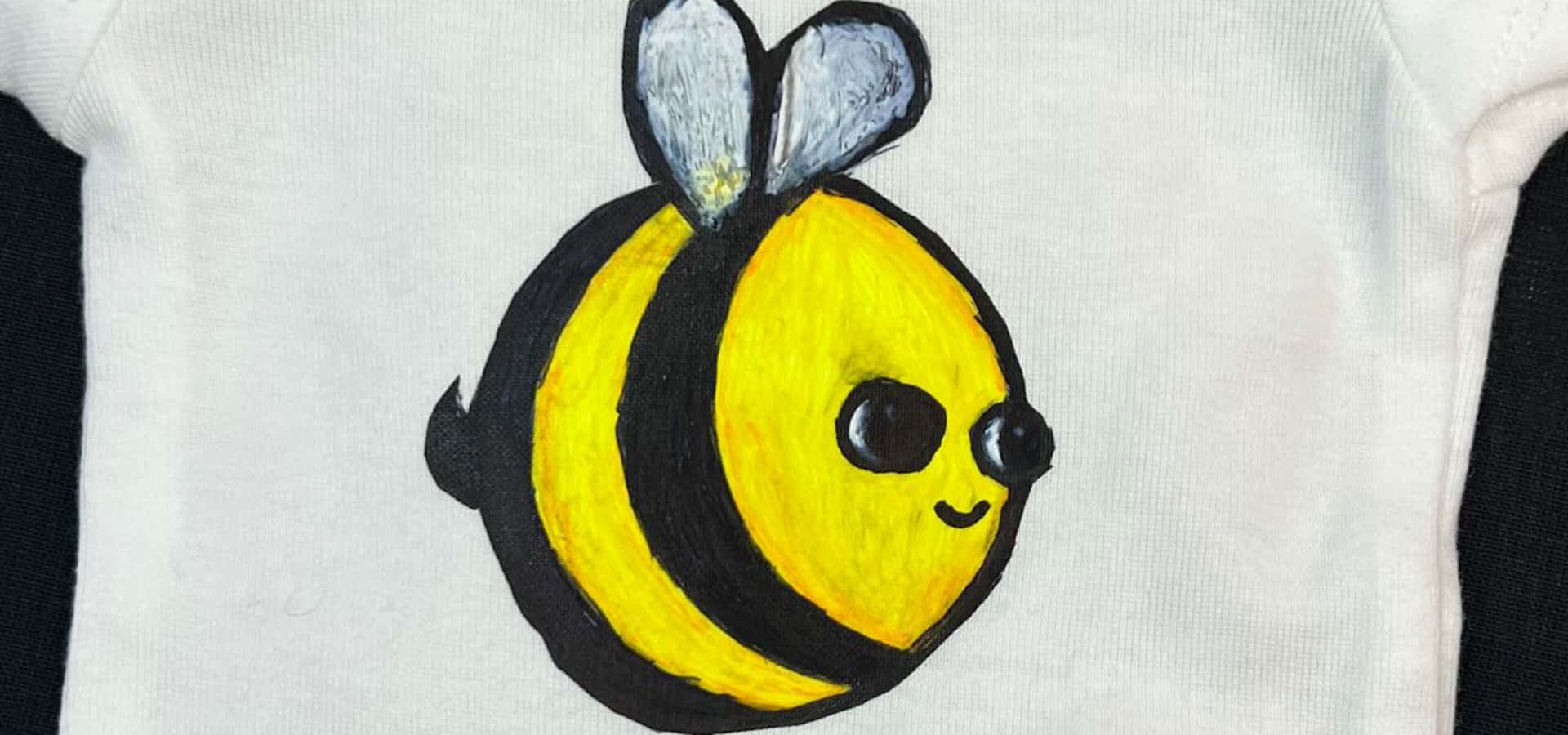 A bee painted onto ThermoFlex® Color Up and pressed onto a shirt